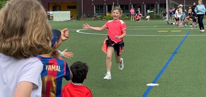 Sportfest, Mädchen läuft auf Schülergruppe zu