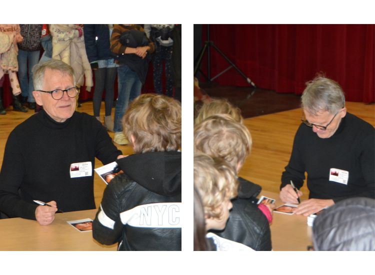 Deutsche Schule Toulouse, Autor schreibt für Kinder Autogramme bei einer Lesung