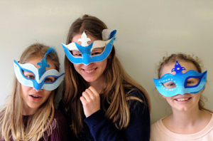 Kunst-AG - drei Schülerinnen mit selbst gebastelten Masken
